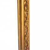 A mirror in a golden frame