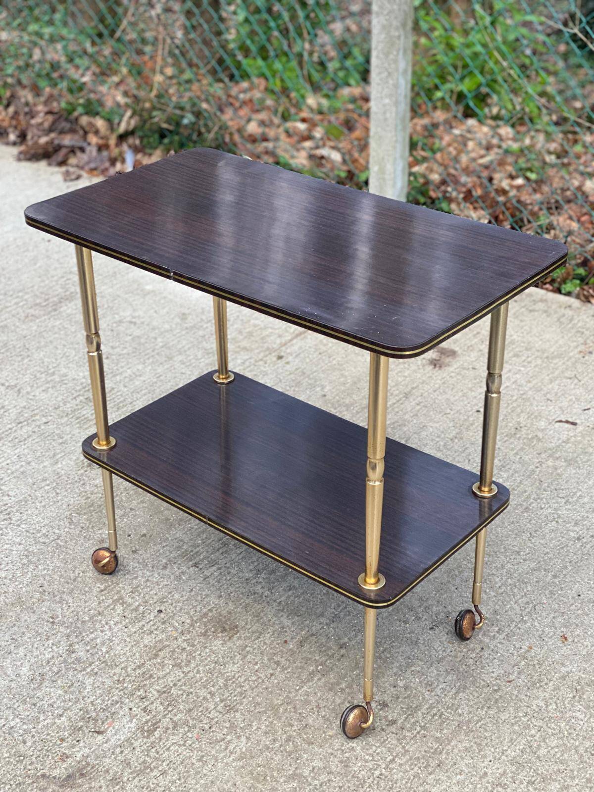 Brown rosewood rolling table with gold legs