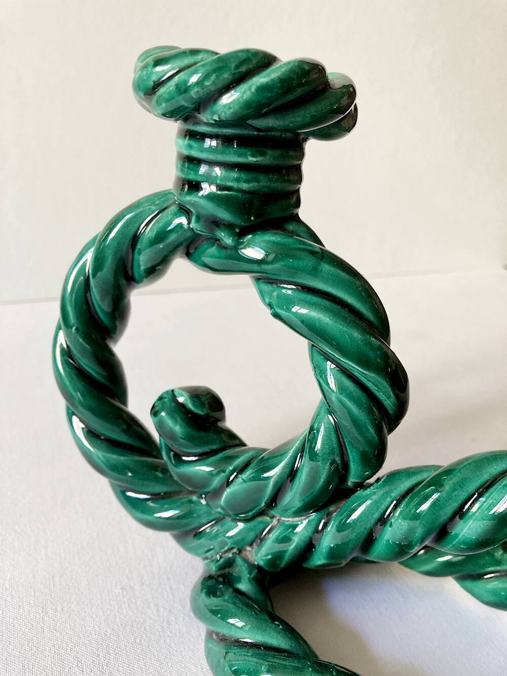 Two-armed candlestick in green glazed ceramic, braided effect