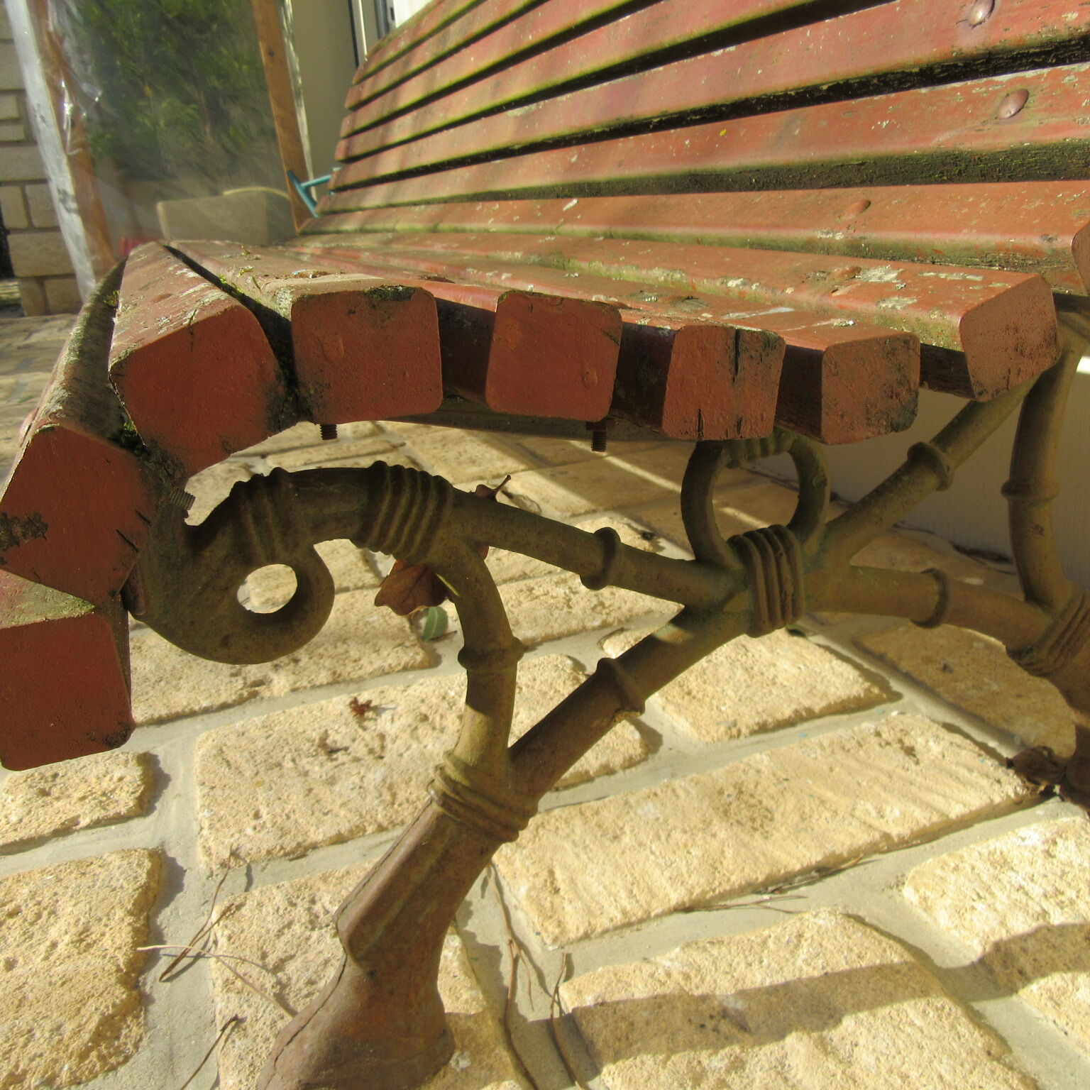 Public bench in wooden slats and cast iron legs