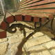 Public bench in wooden slats and cast iron legs