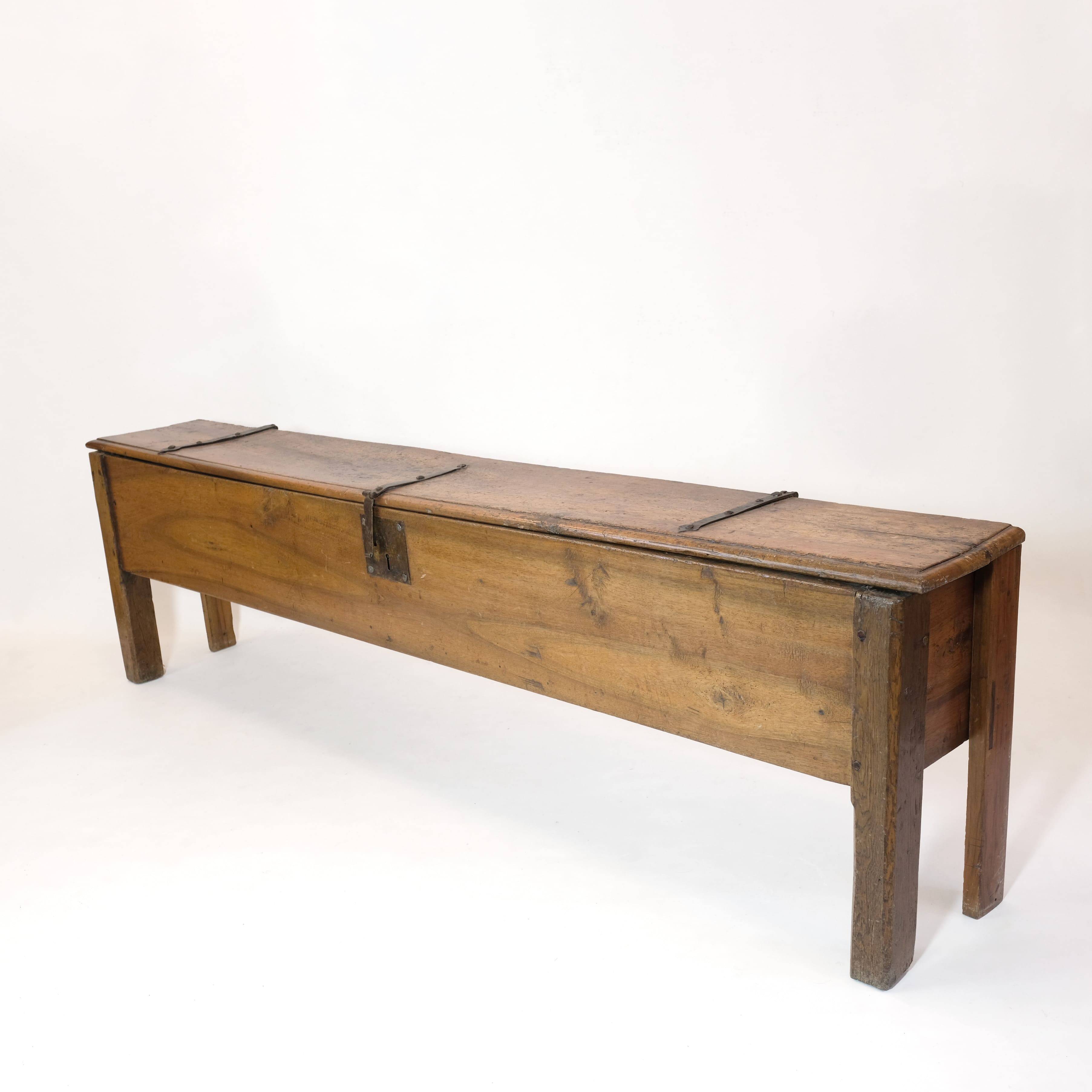 Long walnut grain chest forming a bench, 220cm.