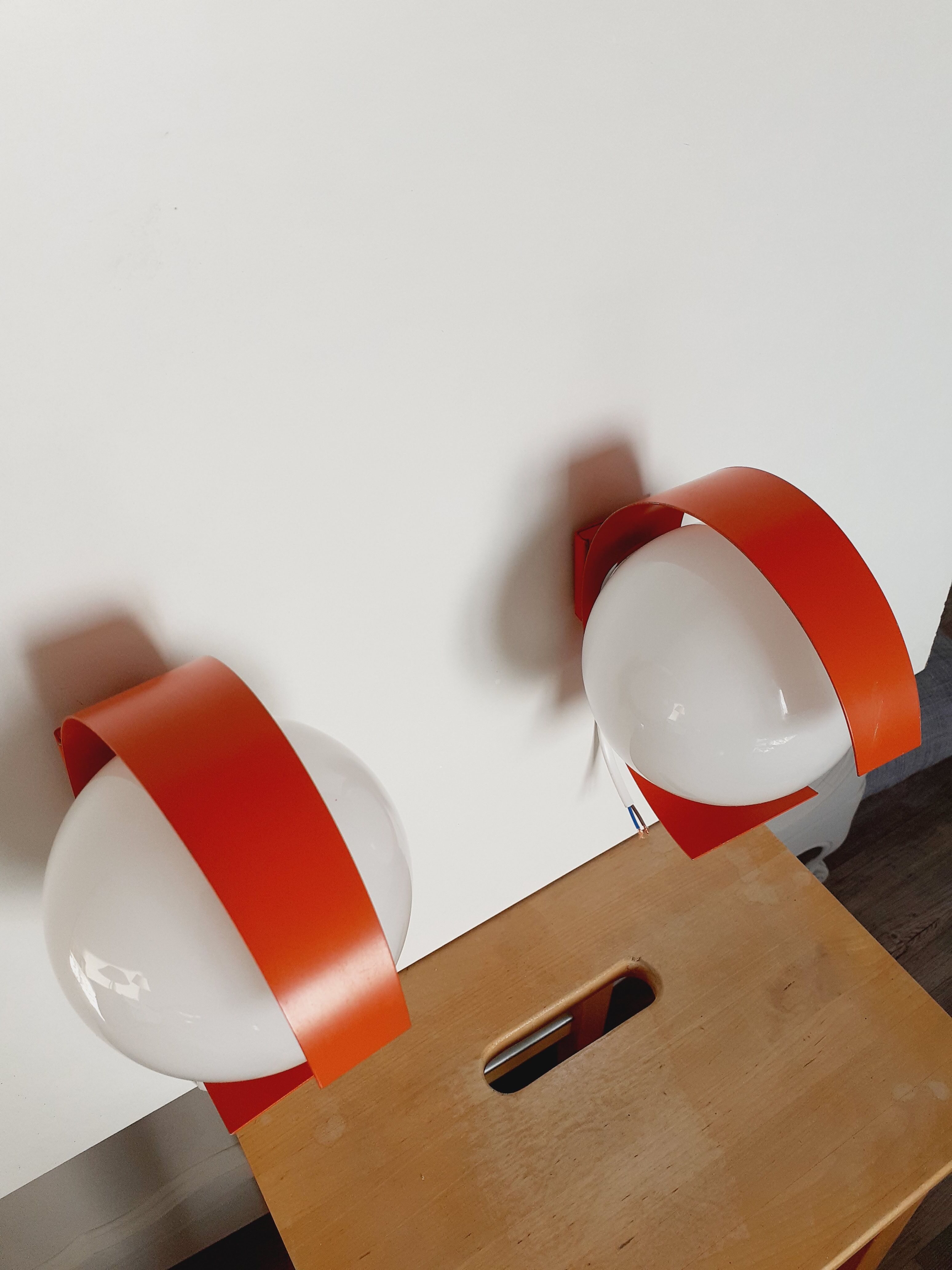 Pair of orange space age wall lamps