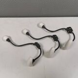 Coat hooks made of galvanized brass and raw white porcelain