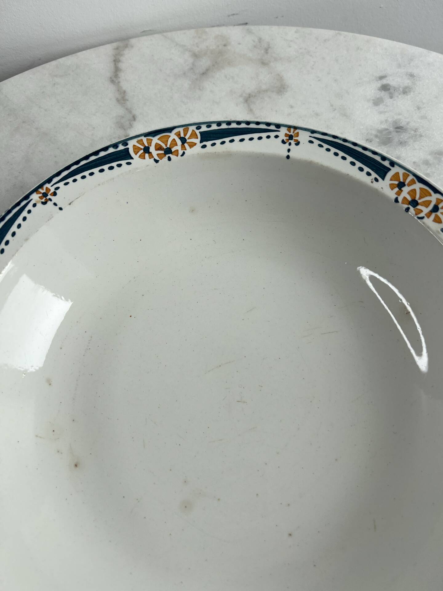 Longwy salad bowl with blue and orange floral decoration.