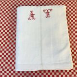 Sheet marked AT in red cross stitch