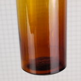 Rummaging in brown glass bottle