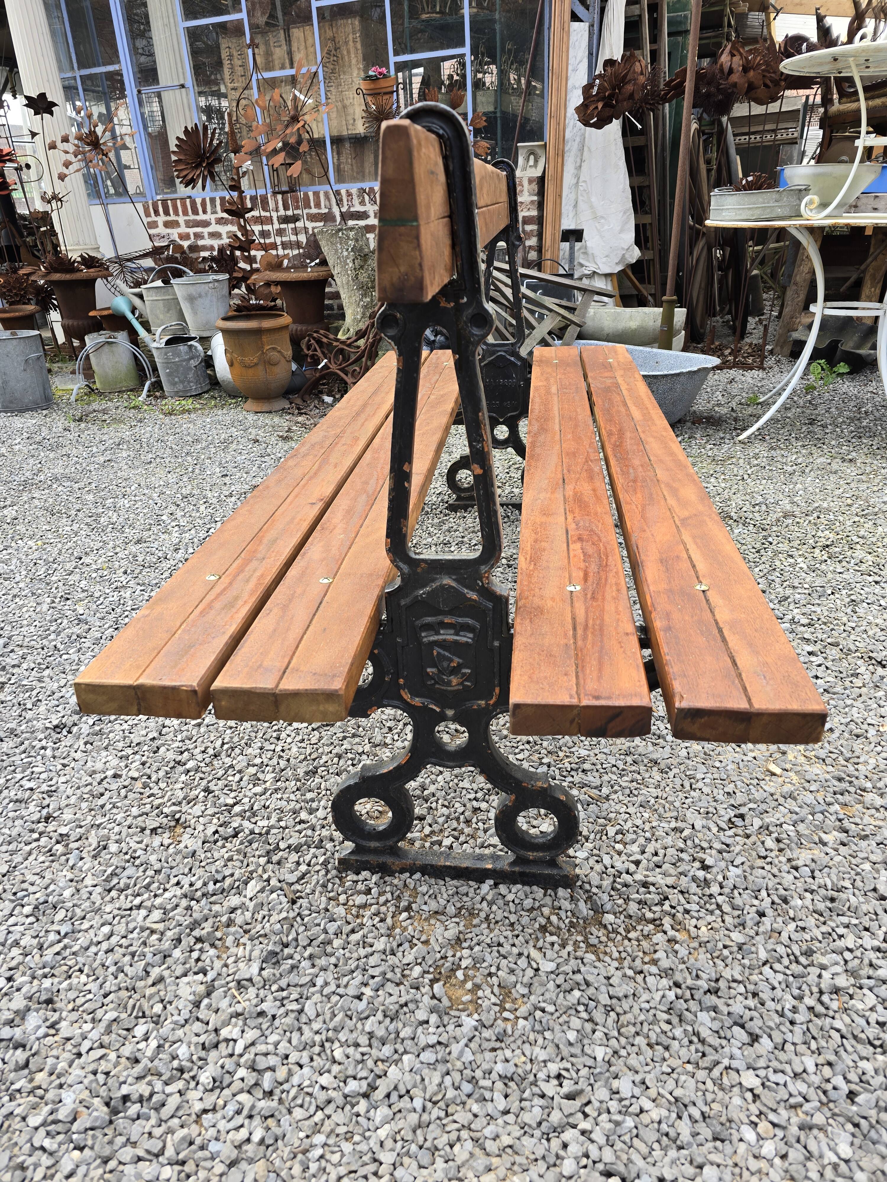 Antique double garden bench from the city of Paris in cast iron and wood