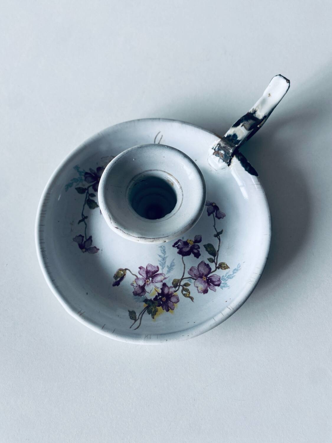 Antique enamelled metal candle holder