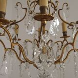 French Louis XV chandelier with 8 lights in gilded bronze, glass and crystal.