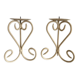 Two beige iron candle holders in a heart shape