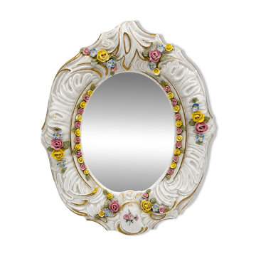 Antique porcelain mirror from Dresden with relief flowers and rococo decoration.