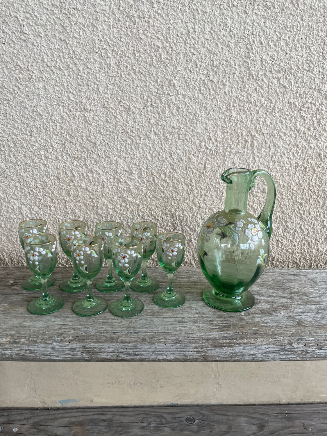Antique liqueur service, enamelled decanter and glasses.
