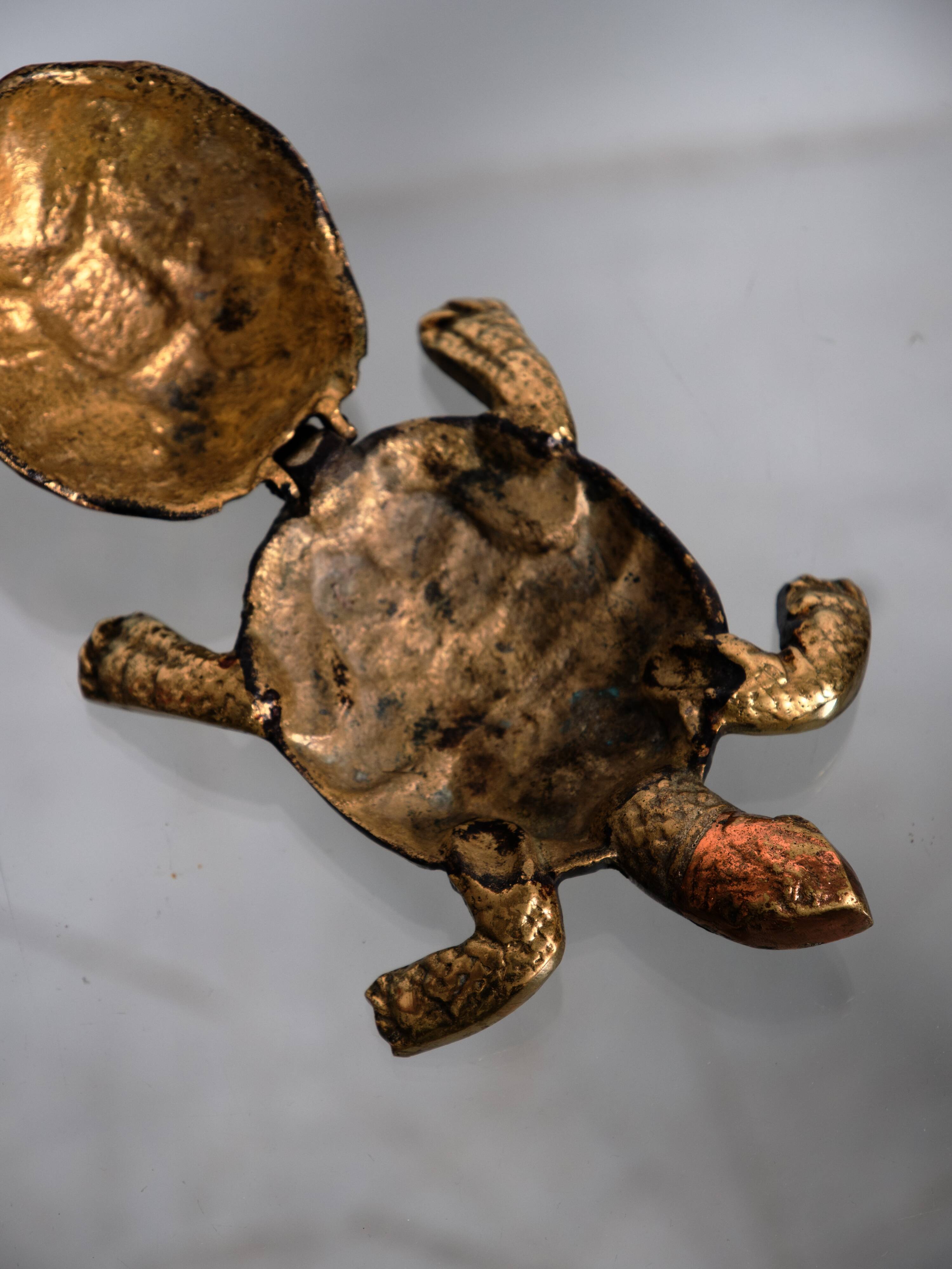 Golden brass turtle in decorative ashtray