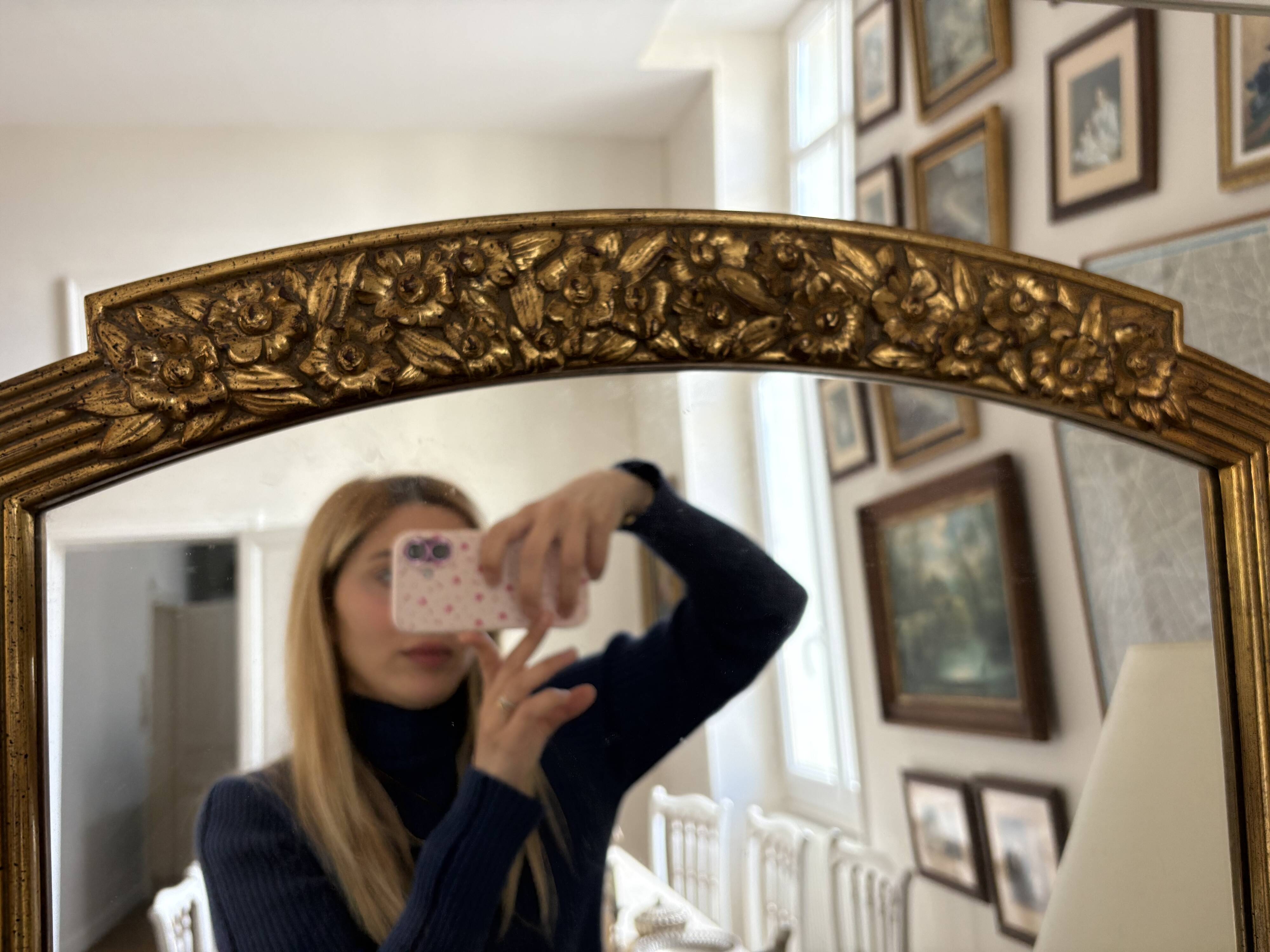 Large vintage gold mirror in Louis XVI style – fluted frame and floral decoration.