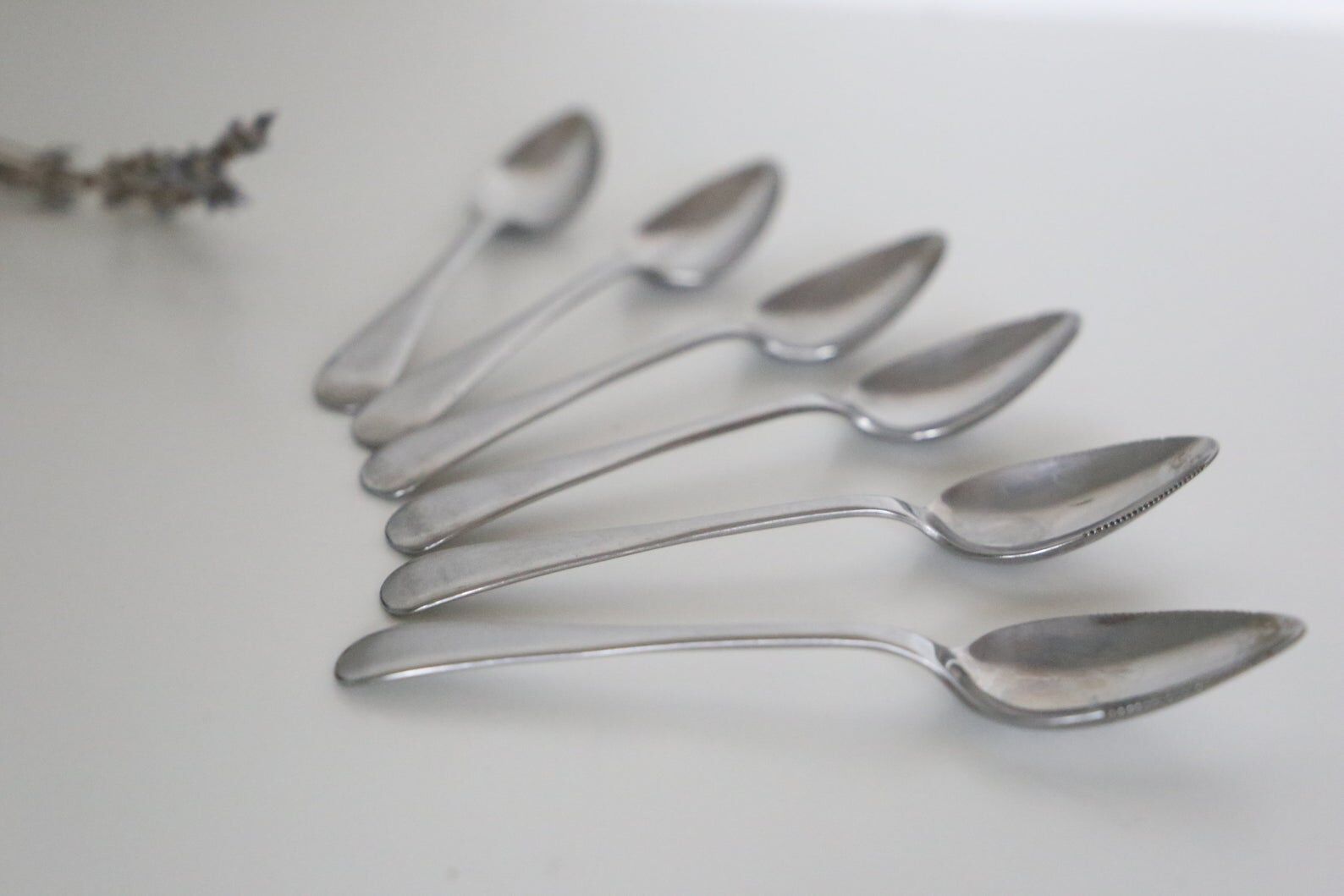 Serving small silver metal notched spoons