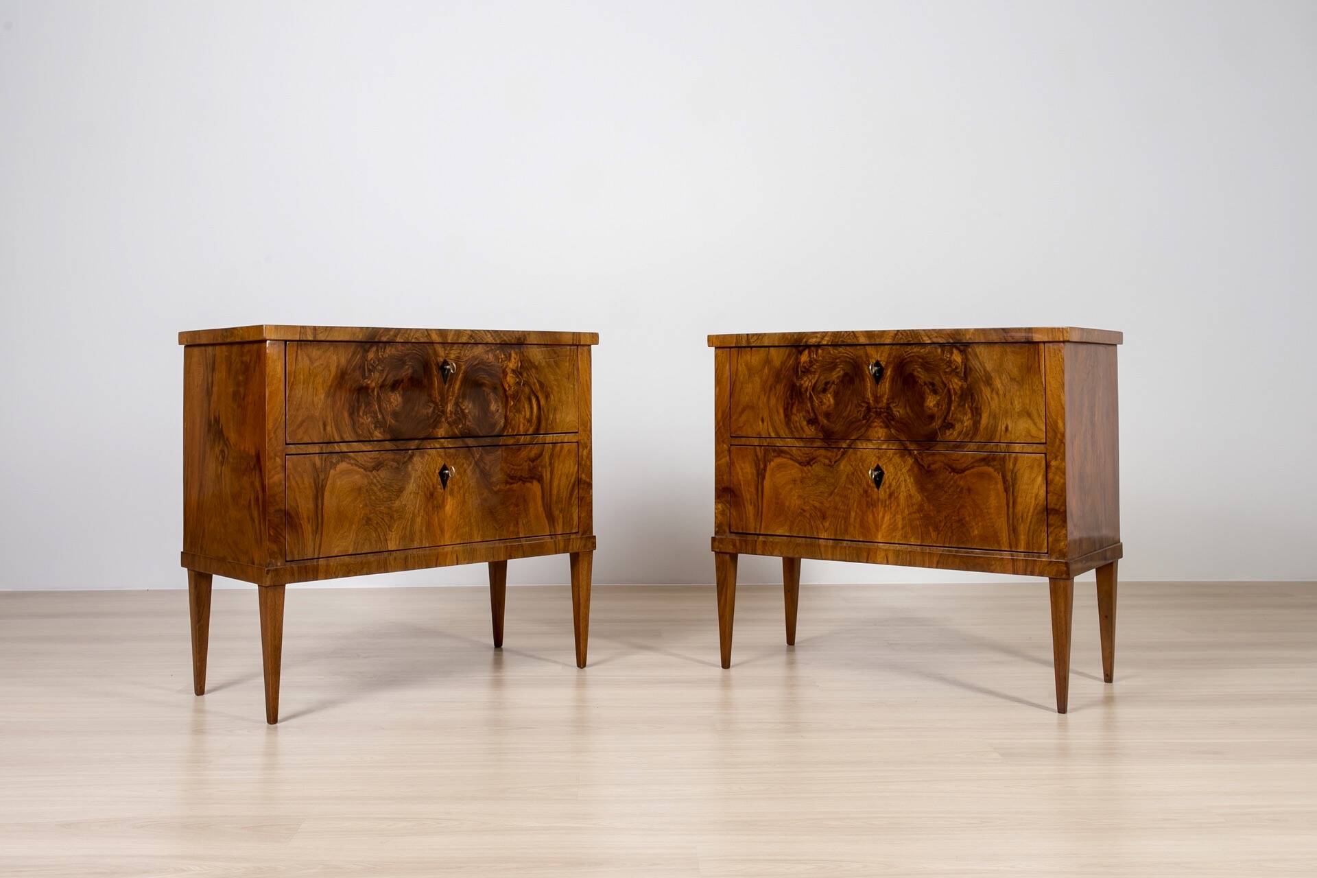 Elegant pair of Biedermeier style walnut commodes, Germany, French polish.