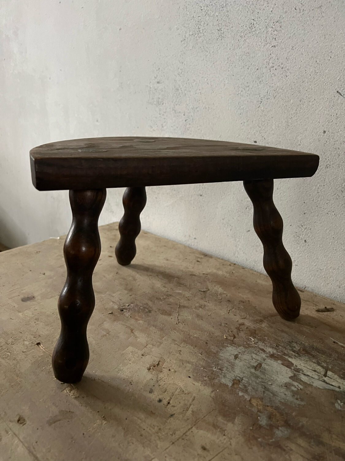 Wooden tripod farm stool