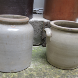 Collection of old sandstone pots with grease and mustard salting