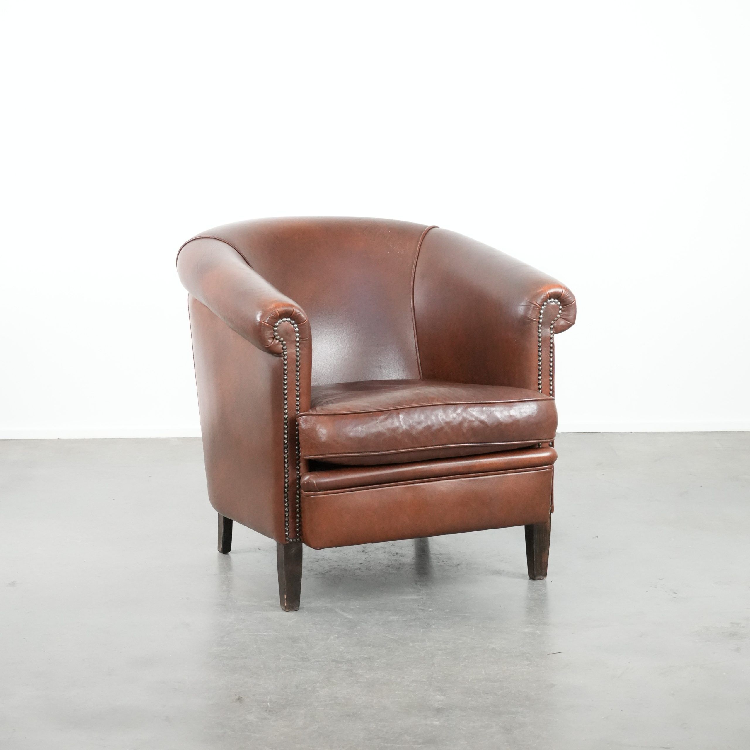 Cognac-coloured cow leather club armchair in English style
