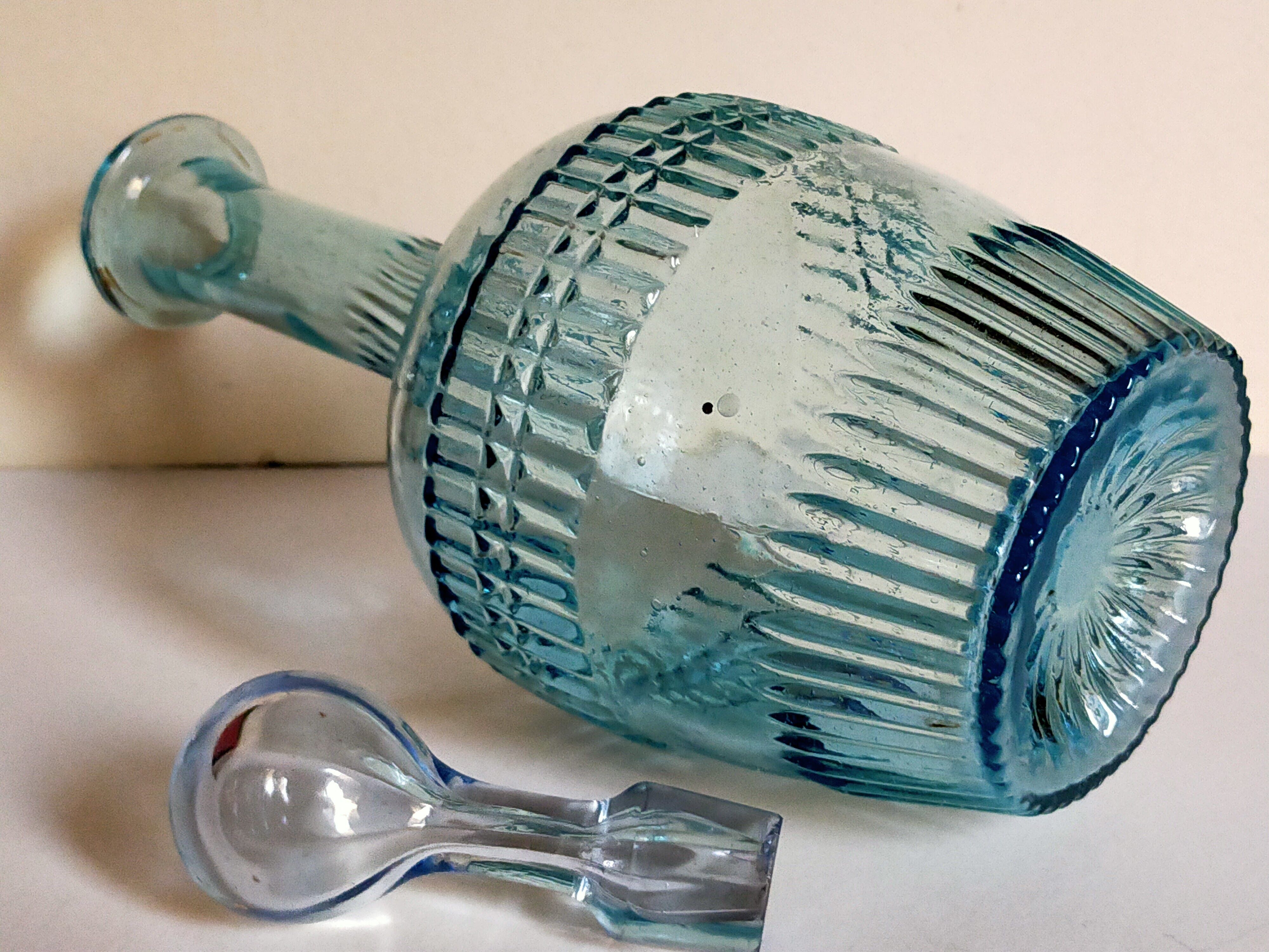 Blue glass carafe with vintage pegs
