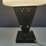 Small stylish table lamp with perforations and milky white opal glass shade