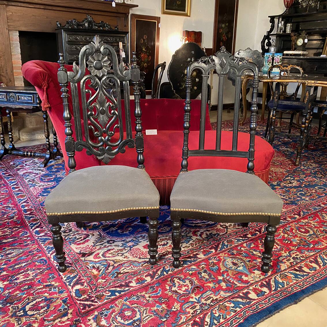 Fake pair of low Napoleon III chairs in blackened wood.