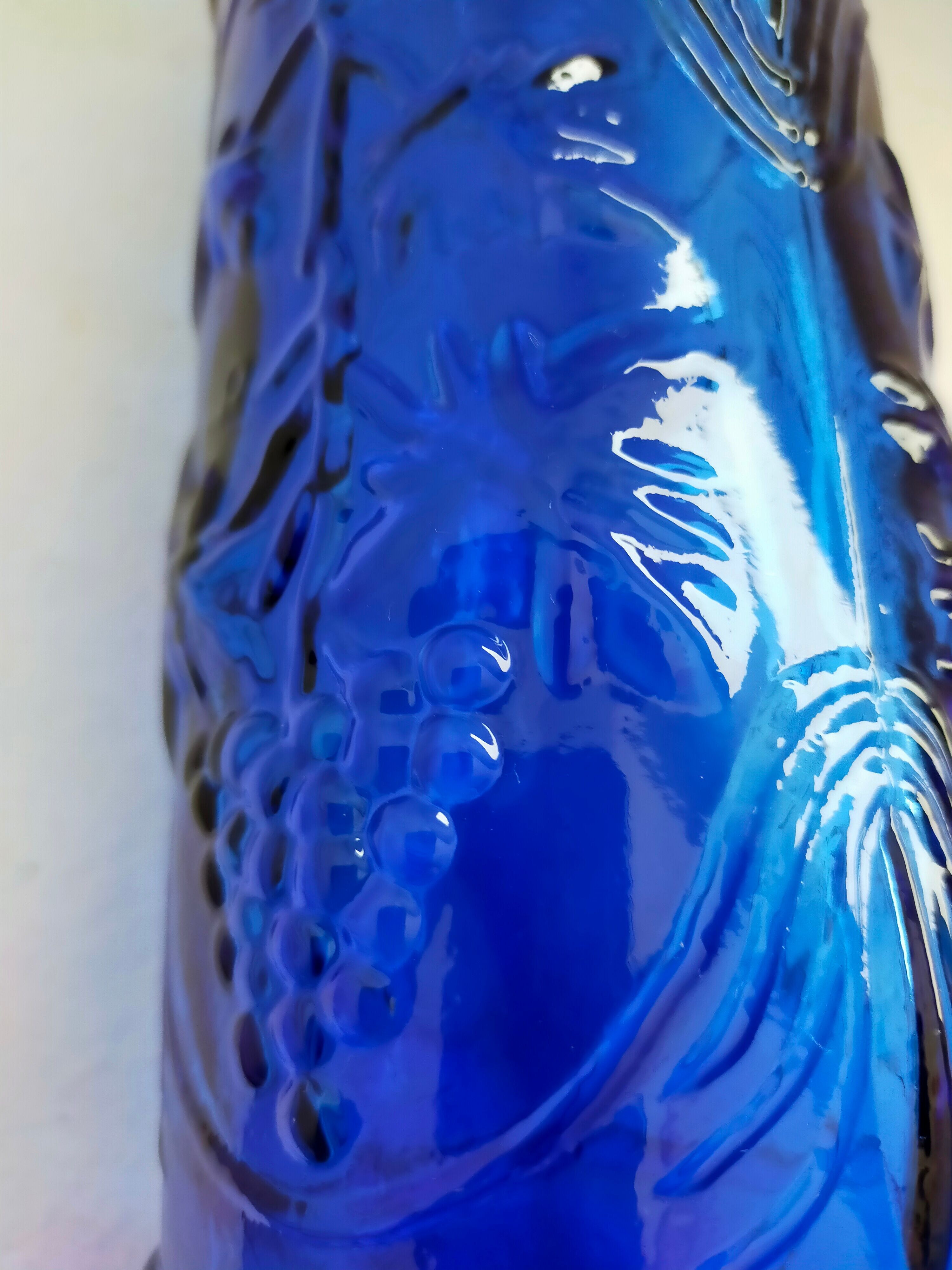 cobalt blue molded glass bottle in relief decoration bunches of grapes