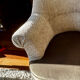 Pair of beige bouclette fabric frog chairs and their footrest.