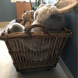 Rattan laundry basket on vintage wheels