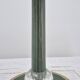 Brass table lamp with green patina and empire-style fabric shade.