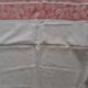 White damask tablecloth. Breve. Large red entourage.