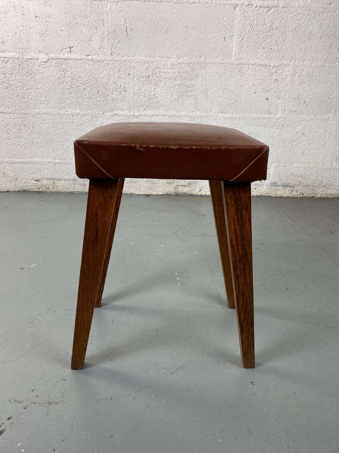 Small stool or footrest in wood and leather