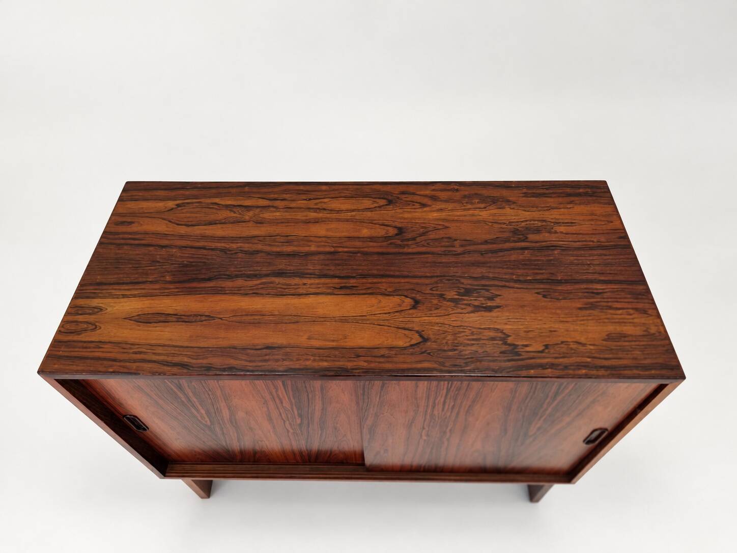 Low sideboard in rosewood with sliding doors. Denmark, 1960s