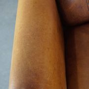 Stately, sleekly finished, comfortable sheepskin armchair