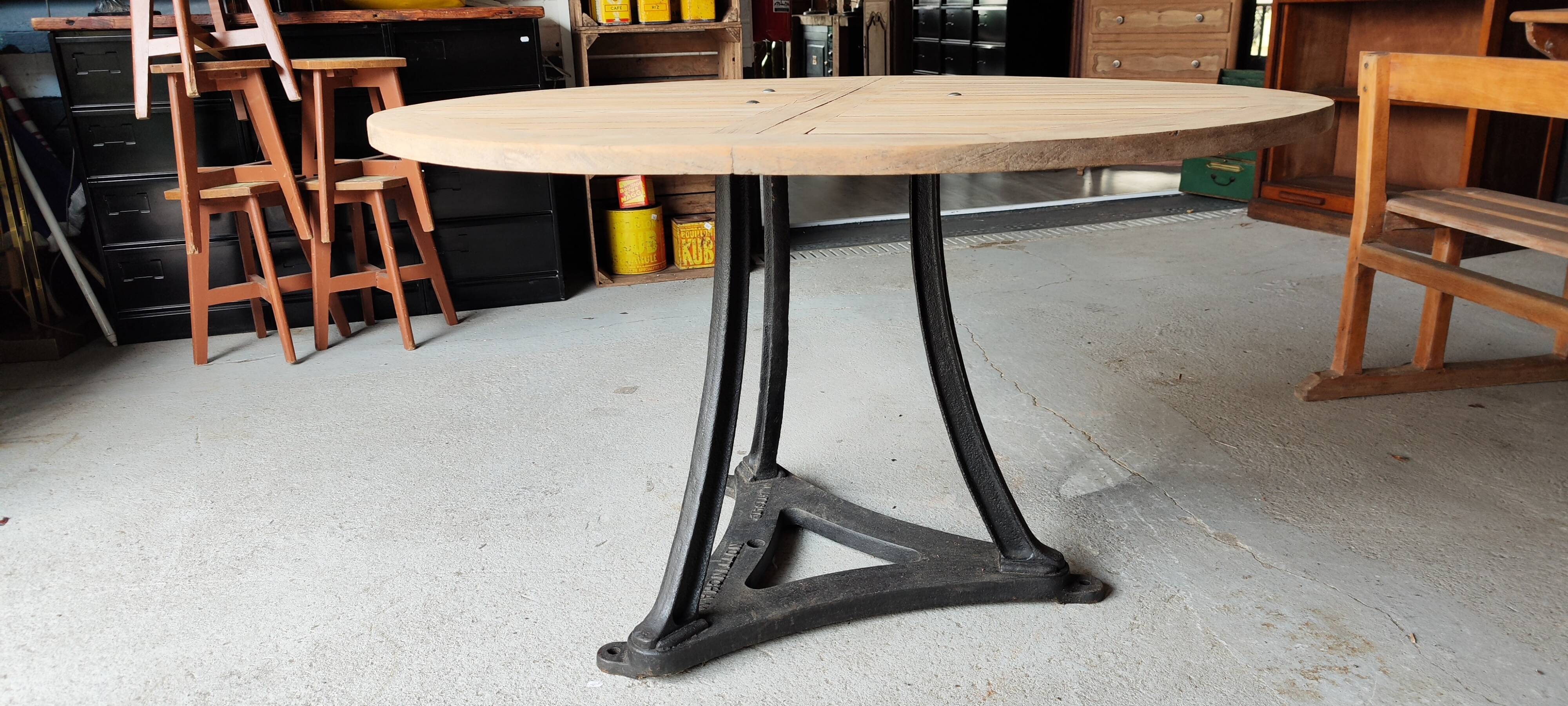 Industrial table with cast iron legs and teak top