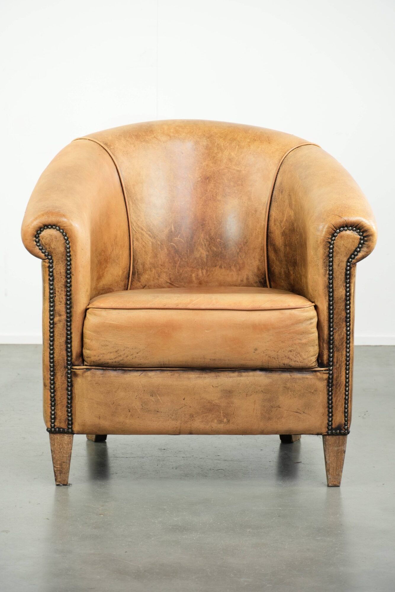 Vintage sheepskin club armchair in a light cognac colour