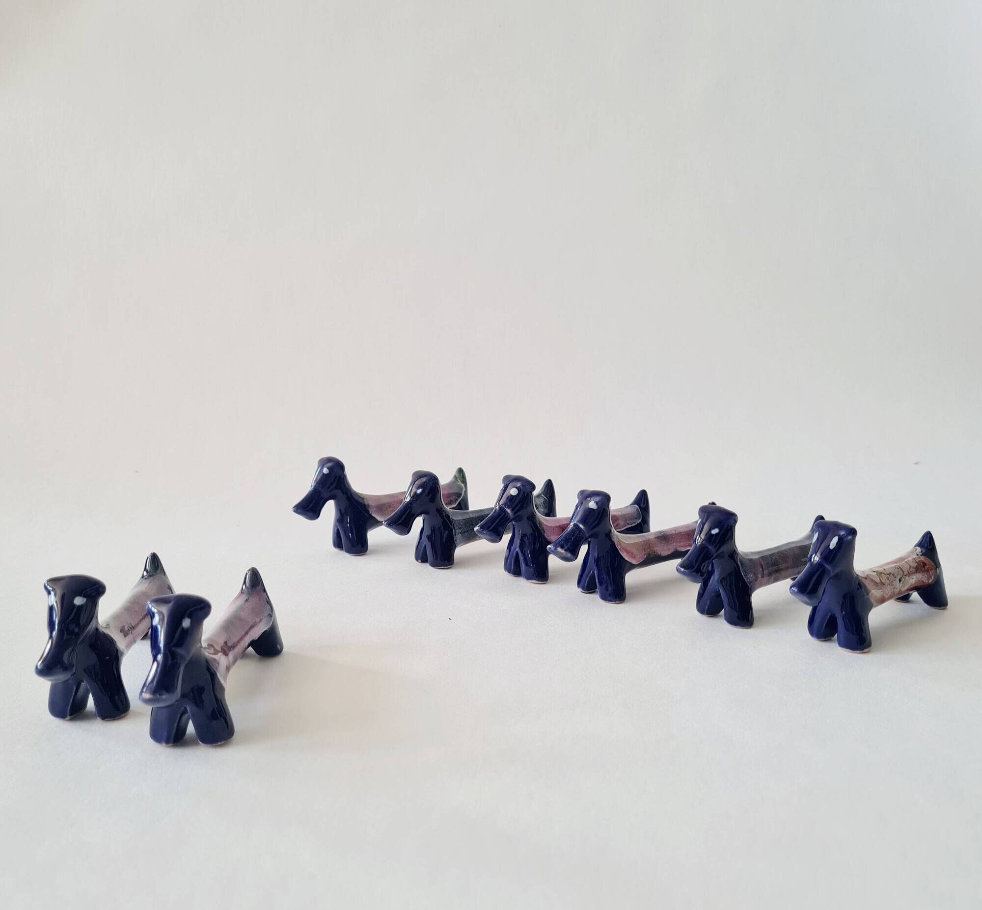Set of 8 vintage ceramic knife rests, retro dog design.