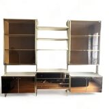 Wall-mounted and modular bookcase in lacquered brass, mirrors and smoked glass by Mahey, Design 1970