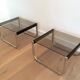 Pair of side tables in chrome, blackened wood and glass.