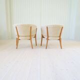Mid-century lounge chairs in sheepskin/shearling and stained wood, Sweden, 1962.