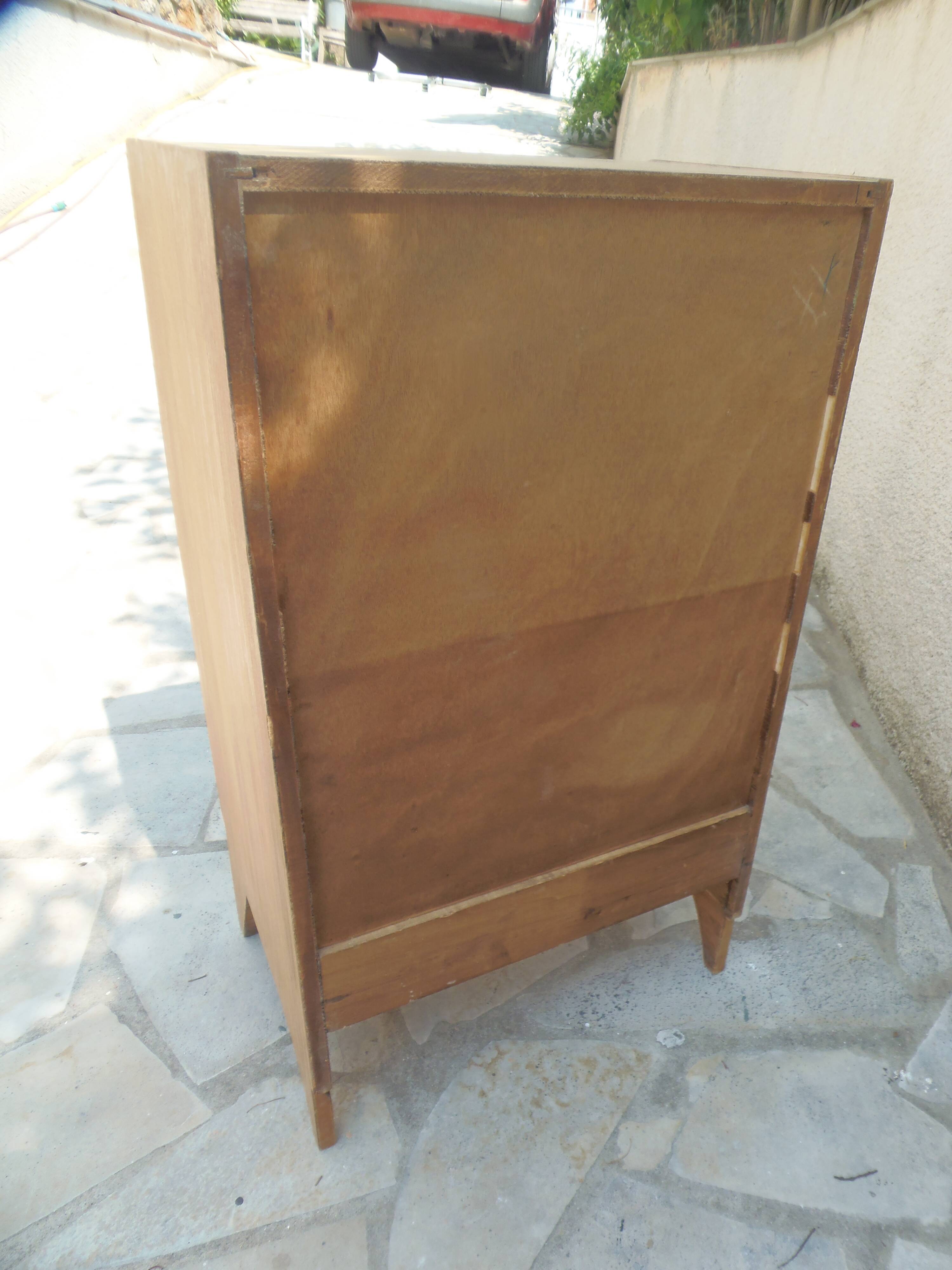 Vintage chest of drawers in raw wood.