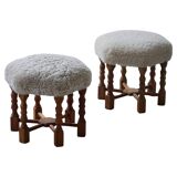 Pair of mid-century Danish oak stools with shearling lambswool upholstery, 1950s.