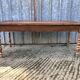 Antique farmhouse table in solid cherry wood with turned legs.