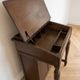 Antique wooden desk with a leather top.