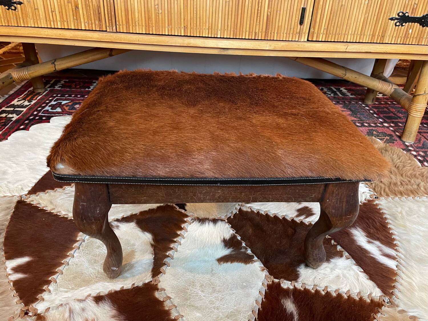 Vintage wooden and goatskin pouf