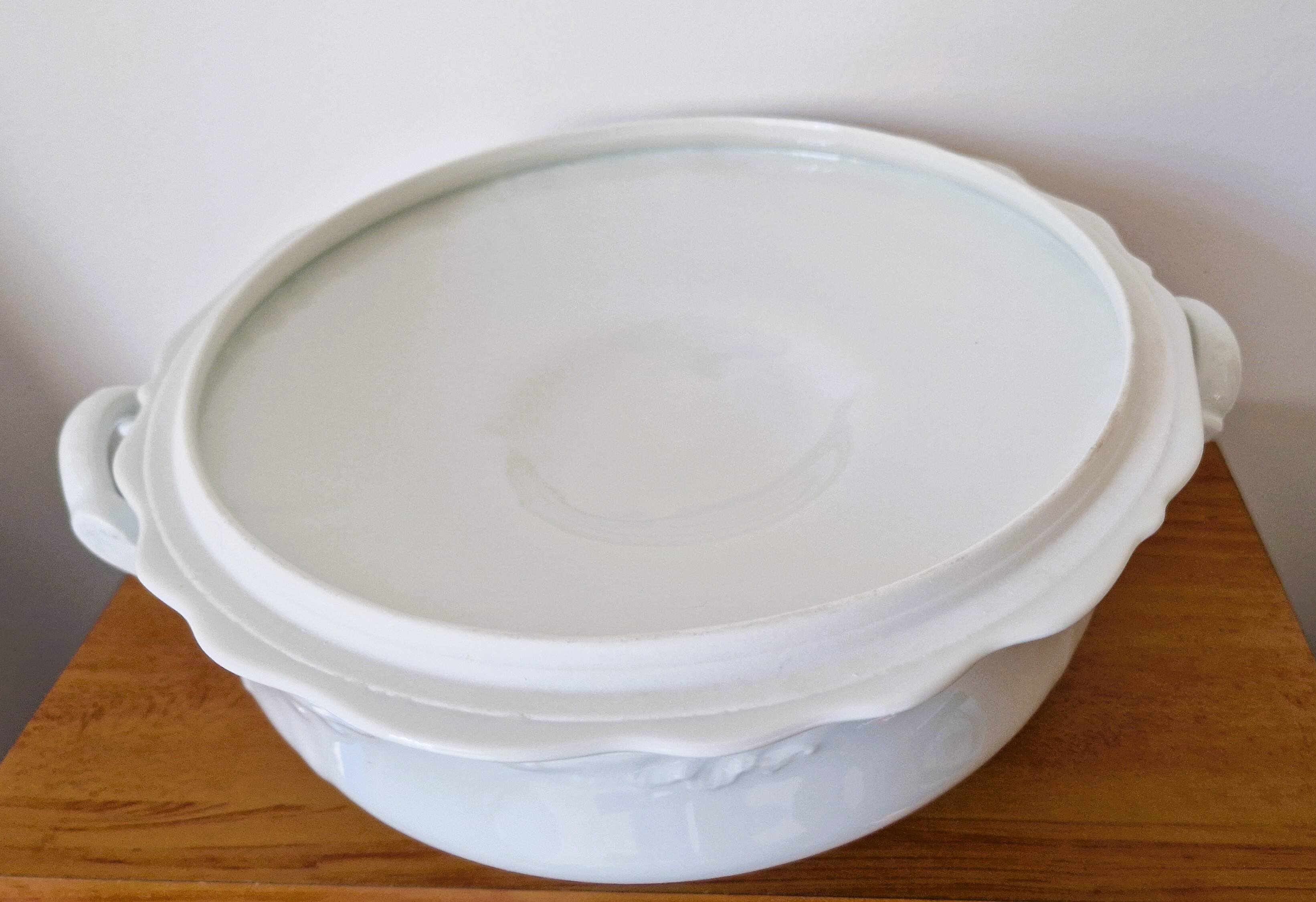 White porcelain soup tureen from Limoges with a vegetal scroll design.