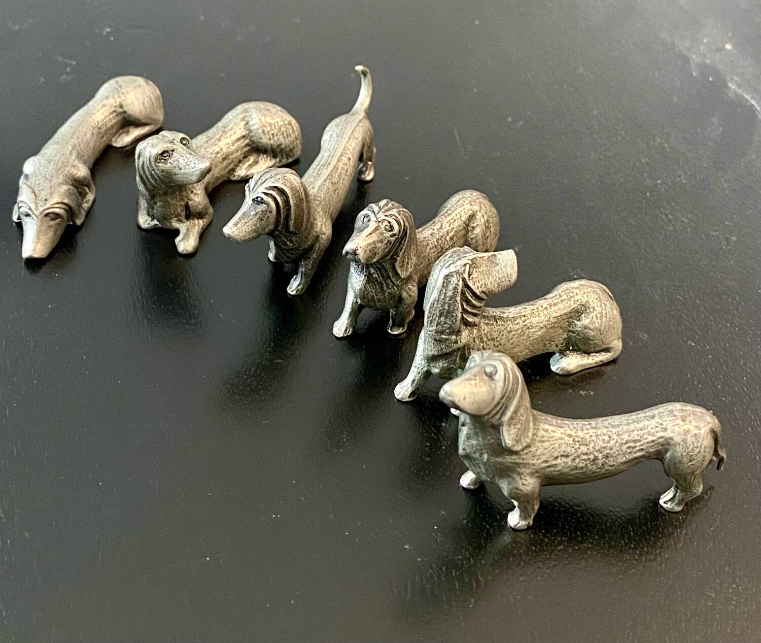 12 old dog-shaped Etains du Manoir knife holders