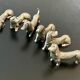 12 old dog-shaped Etains du Manoir knife holders