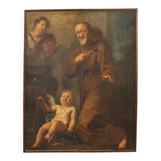 Antique painting of a Franciscan saint in prayer with cherubs from the 17th